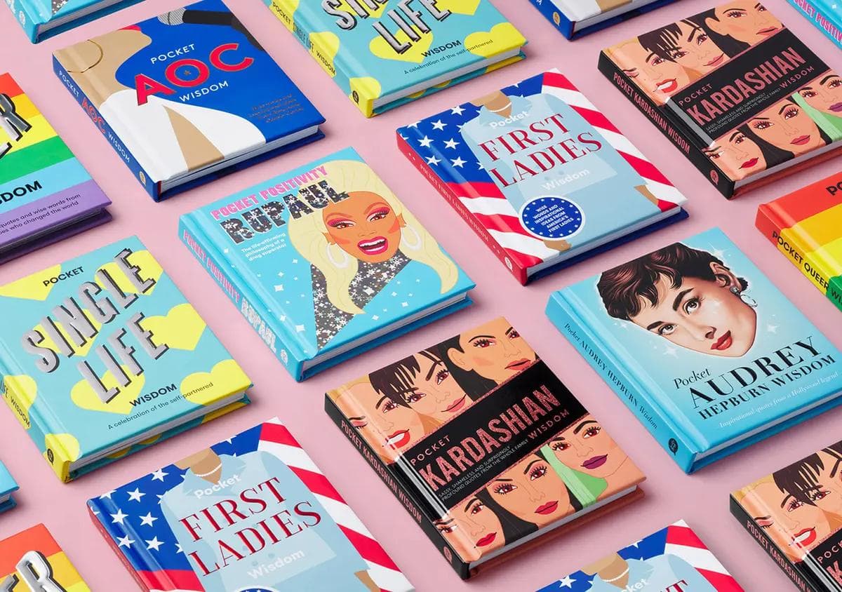 A flat-lay of multiple "Pocket Wisdom" books arranged in a grid on a pink background, featuring brightly coloured illustrated covers including "Pocket RuPaul", "Pocket Audrey Hepburn", "Pocket Kardashians", "Pocket AOC", "Pocket First Ladies", and "Single Life Wisdom", with bold typography, pop-art portraits, and varied colour palettes.