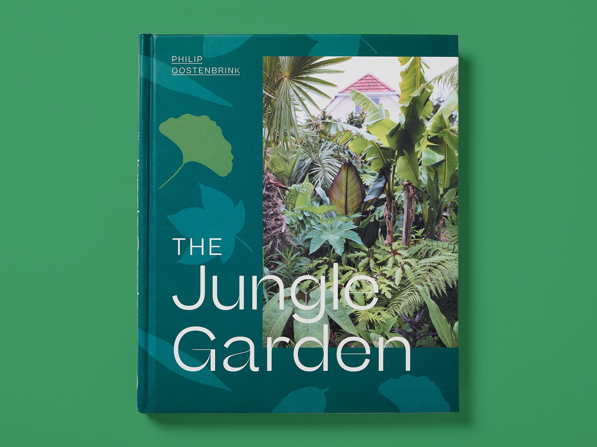 Dark green book cover titled "The Jungle Garden" by Philip Oostenbrink, featuring a photograph of a lush tropical garden with large-leaf plants and palms, layered with subtle botanical graphics and white typography, set against a green background.