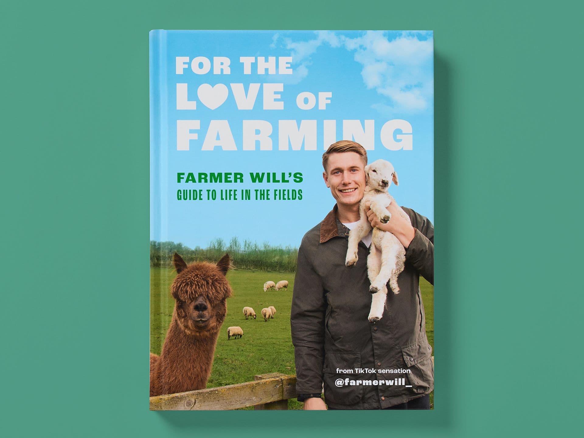Book cover titled "For the Love of Farming" on a green background. Blue sky design with large white title text and green subtitle reading "Farmer Will’s guide to life in the fields." A smiling farmer holds a lamb in a grassy field, with sheep grazing behind and an alpaca in the foreground.